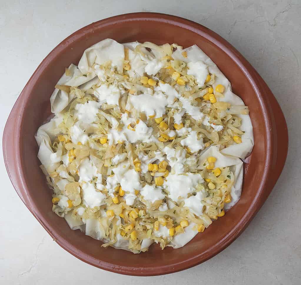 image showing how to add sour cream mixed with eggs between the layers